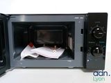 a microwave that has a bunch of papers inside of it