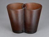 pair of brown glass vases sitting on top of a gray surface