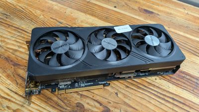 a close up of a video card sitting on top of a wooden table