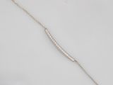 a close up of a silver necklace on a white surface