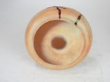 a vase that has a hole in the middle of it