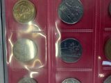 a display case with a lot of different coins in it