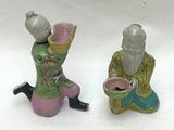 two figurines that are sitting next to each other