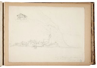 an open book with a drawing of a mountain in the background