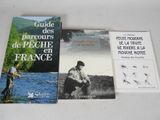 two books on a table with a man fishing in the water