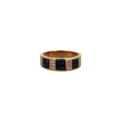 a close up of a gold ring with blue sapphires and diamonds