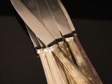 four forks and a knife on a black table