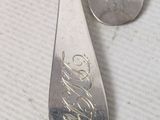 two spoons that are sitting on a table