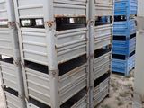 many crates stacked on top of each other in the dirt