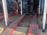 une image d'un garage avec de nombreux outils sur le sol