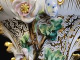 a vase with flowers on it sitting on a table
