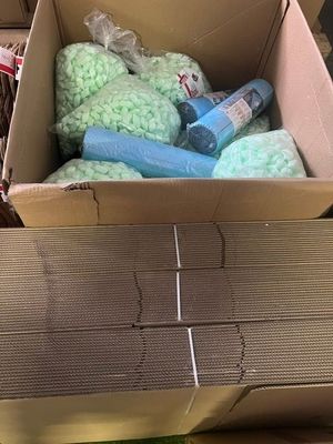 a cardboard box filled with assorted items on a table