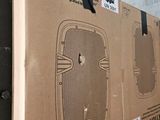 a cardboard box sitting on top of a pile of boxes