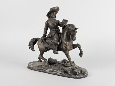 statue en bronze représentant un homme à cheval accompagné d'un chien