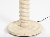 a white table lamp that is on a white table