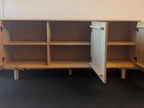 a wooden cabinet with two doors open in a room