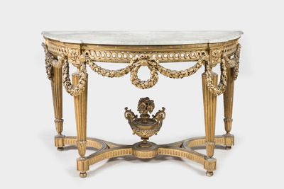 an antique console table with a marble top and gold leaf decoration