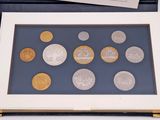 a picture of a picture of some coins in a box