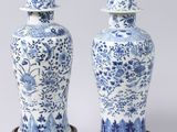pair of blue and white vases with birds and flowers on them