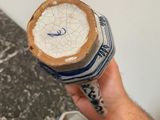 a person holding a can of beer in their hand