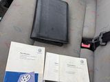 a seat belt and a book on the seat of a car