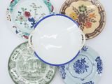 four plates with different designs and designs on them on a white surface