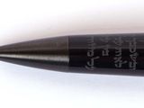 a black pen with writing on it on a white surface