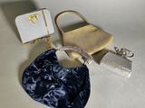 two purses and a purse bag sitting on top of a table