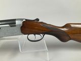 a shotgun with a wooden handle and a metal body