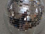 a shiny disco ball sitting on the ground in the middle of the street