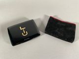 a close up of a small black case with a gold logo on it