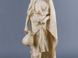 statue of a woman holding a bucket and a pot on a pedestal