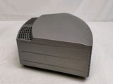 a close up of a small gray device on a white surface