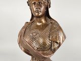 a bronze busturine of a woman with a crown on her head