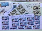 a lot of stamps that are on a bulletin board