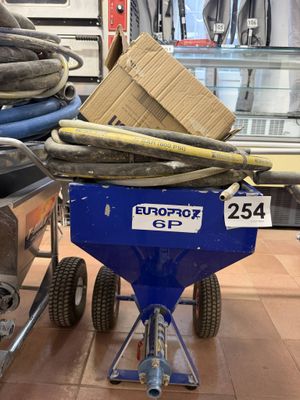 a blue cart with a box on top of it in a store