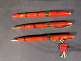three pens that are sitting next to each other on a table