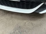 a close up of a car ' s front grill with a number plate on it