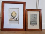 two framed pictures of a hot air balloon on the floor