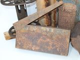 a lot of rusty objects that are sitting on a table