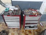 two tool boxes with tools on top of them on the floor
