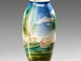 a vase with a painting on it sitting on a table