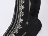 black and white socks with a design on them on a white surface