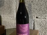 a bottle of wine sitting on top of a cardboard box