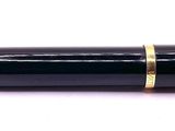a pen that is laying on a white surface