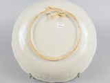 a white plate with a yellow rope on it