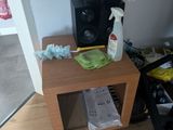 a wooden table with a bottle of cleaner on top of it