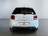 the rear end of a white car in a white room
