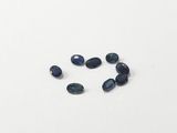 a group of blue sapphires on a white surface