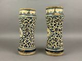 pair of blue and white vases sitting on top of a table